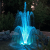 Wiedamark LED Floating Fountain with RGB lights creating a colorful water display in a serene pond at night.